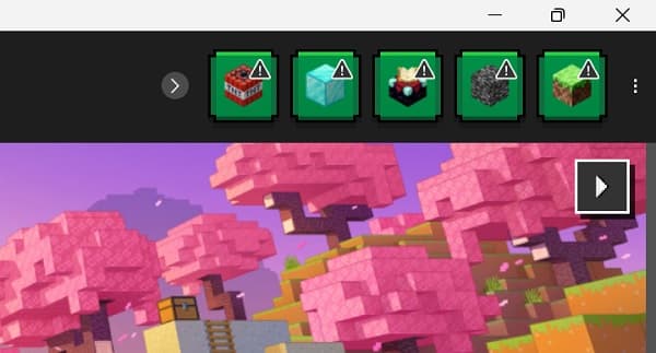 A person using a laptop and phone at a modern desk.