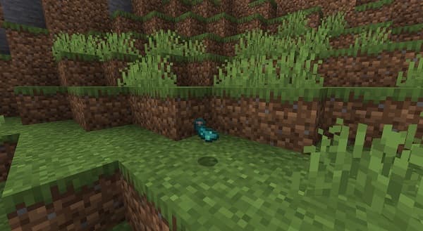 A modern office building facade with large windows reflecting the sky.