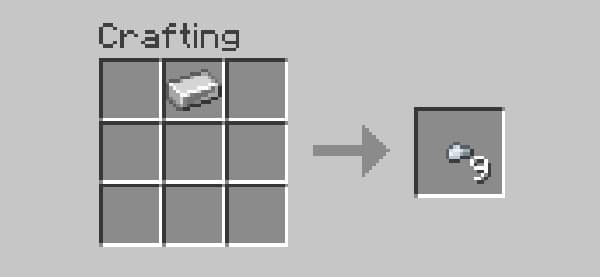 Blueberries on a branch with green leaves.