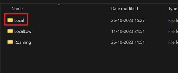 Empty office cubicle with a red chair and whiteboard.