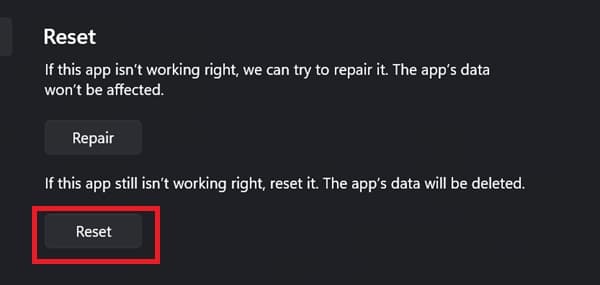 A child's hand holding a blue toy car.