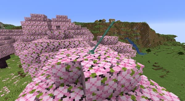 Brown leather sofa with striped pillows in a modern living room.