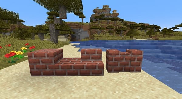 A lone car drives on a winding road through a snow-covered forest.