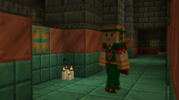 Young man with a focused expression working on his laptop, surrounded by books, in a cozy home office setting.