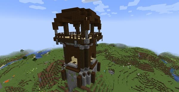 A young woman with dark hair in a ponytail smiles and looks at her phone in a cafe.