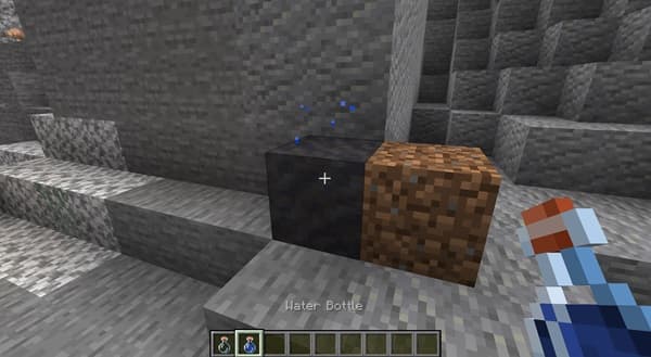 A serene lake reflecting mountains under a clear sky.