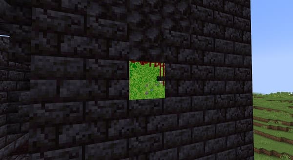 A hand holds a magnifying glass over a blurred document.