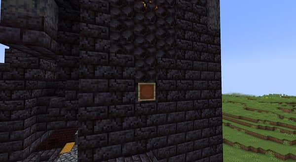 A person's hand pressing a button on a control panel.