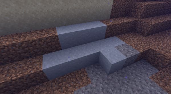 A small, light brown puppy with floppy ears gazes upwards.